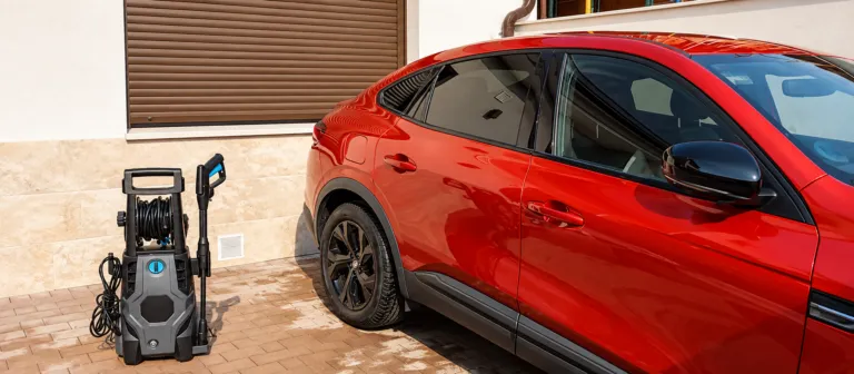 Cecotec HydroBoost 2400 AdvanceClean junto a un coche rojo en el patio